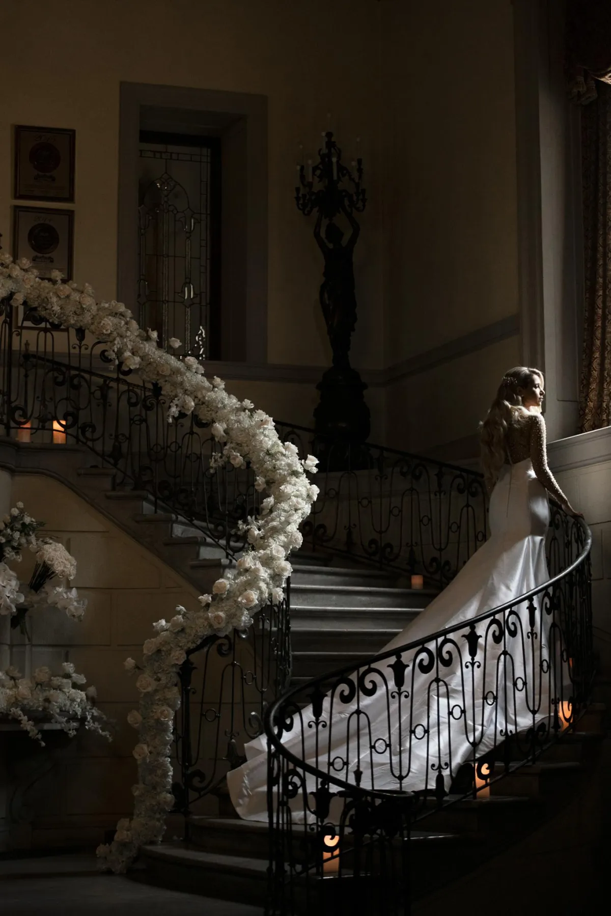 Oheka Castle wedding photographer bride walking on grand staircase inside castle Long Island NY by Lotus Wedding Photography