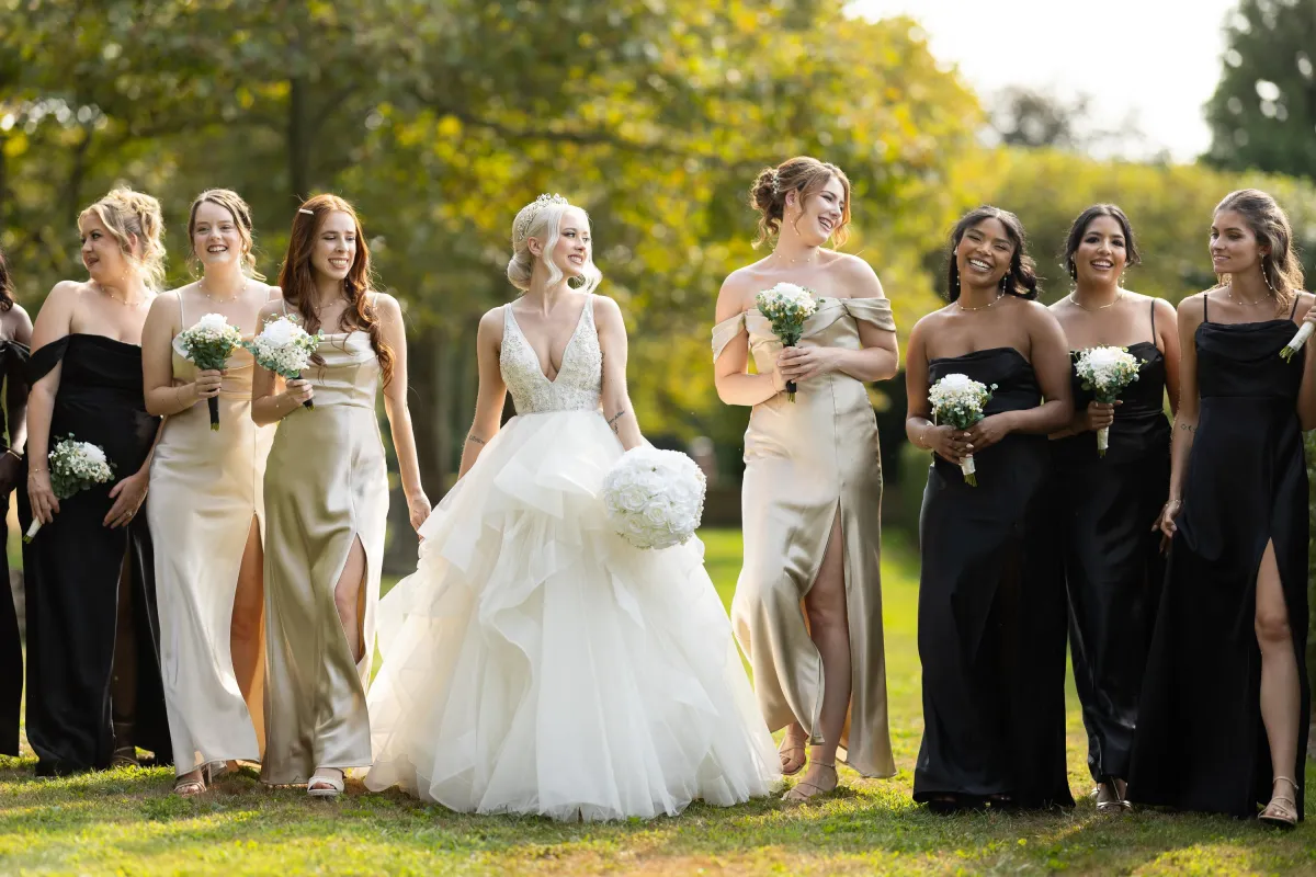 Oheka Castle wedding photographer bride walking with bridesmaids garden Long Island NY by Lotus Wedding Photography
