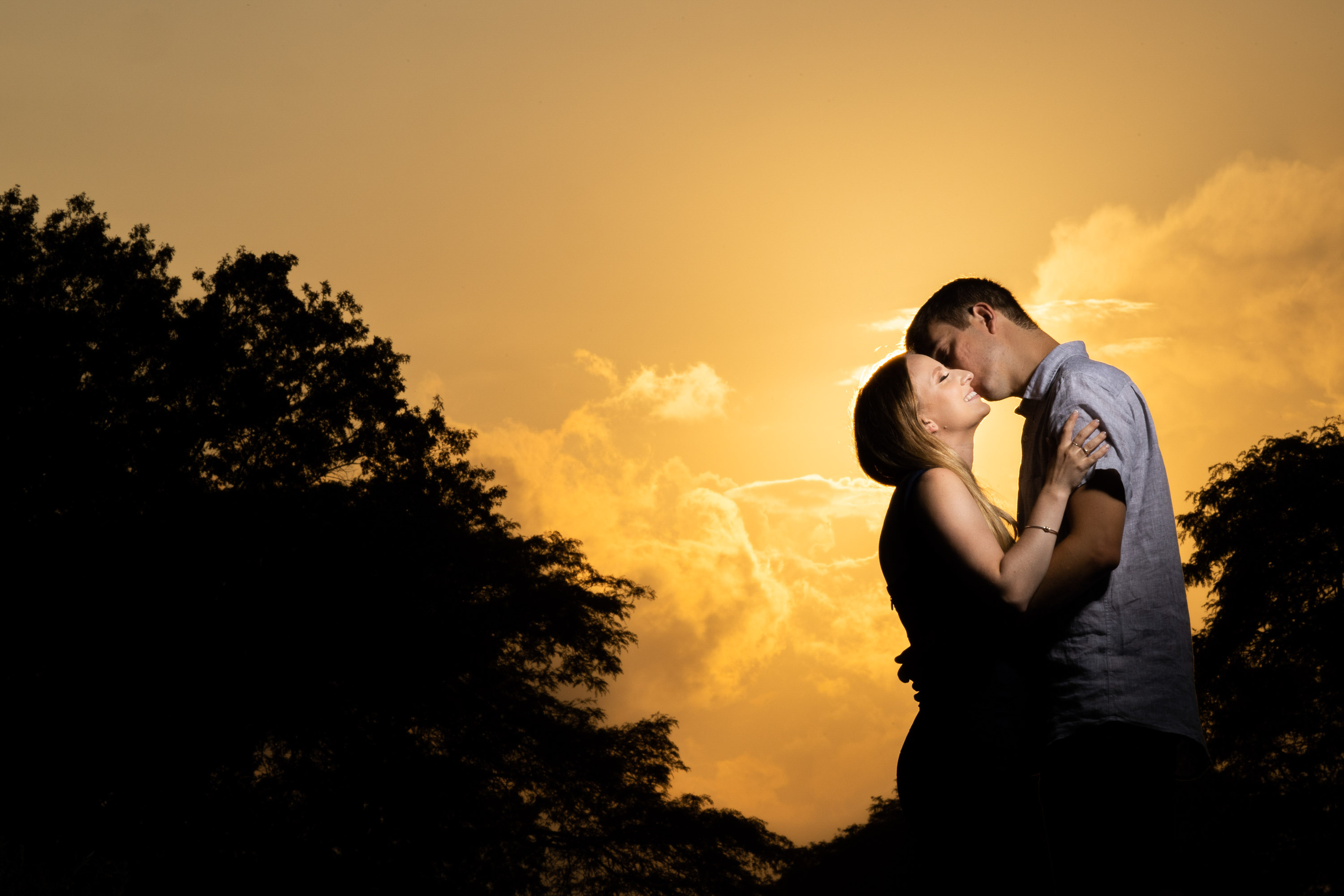 sunset silhouette engagement photo of couple embracing in Dallas Texas photographed by Dallas engagement photographer Lotus Wedding Photography