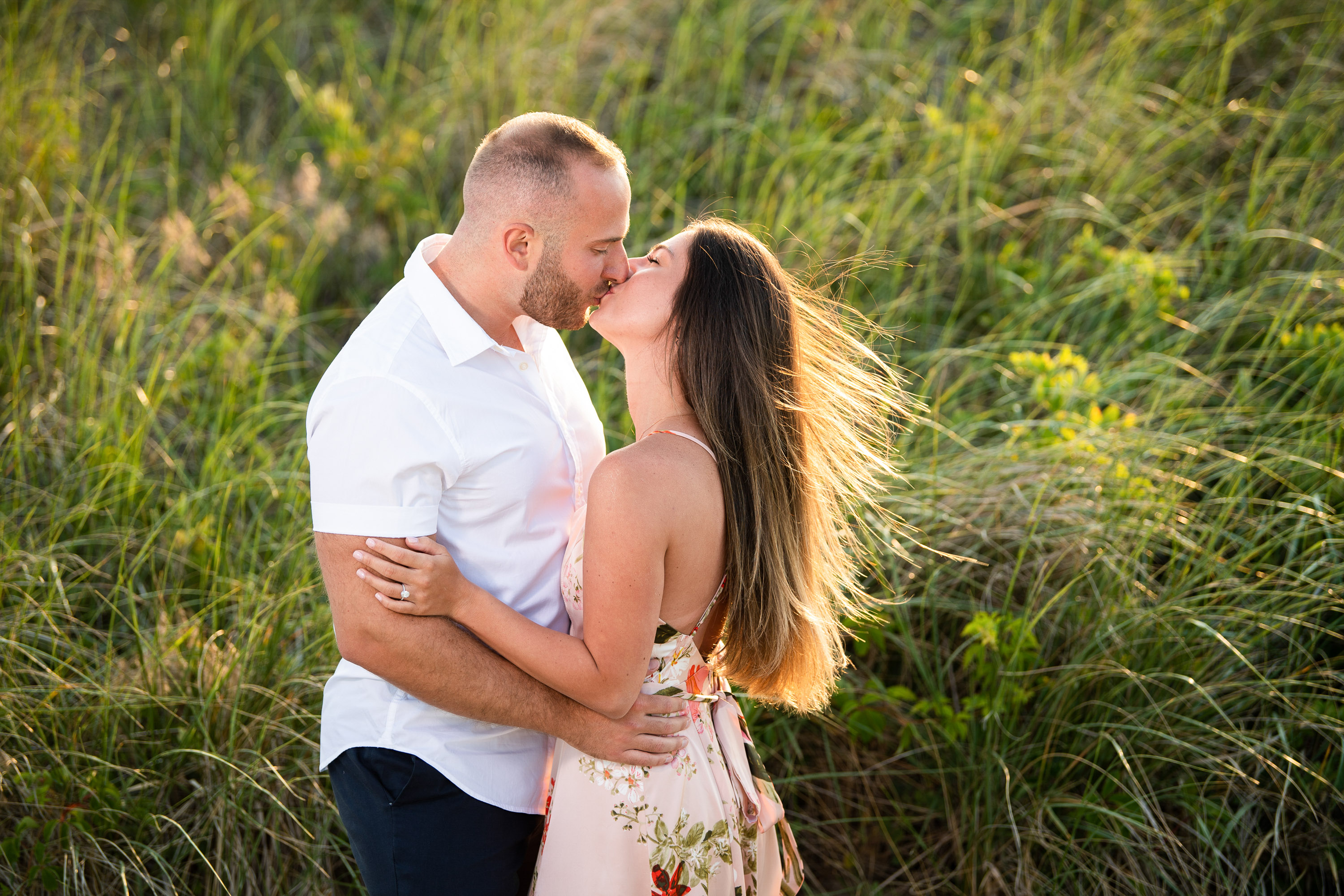 romantic engagement photos at Arbor Hills Nature Preserve Dallas with couple kissing in tall grass photographed by Dallas engagement photographer Lotus Wedding Photography