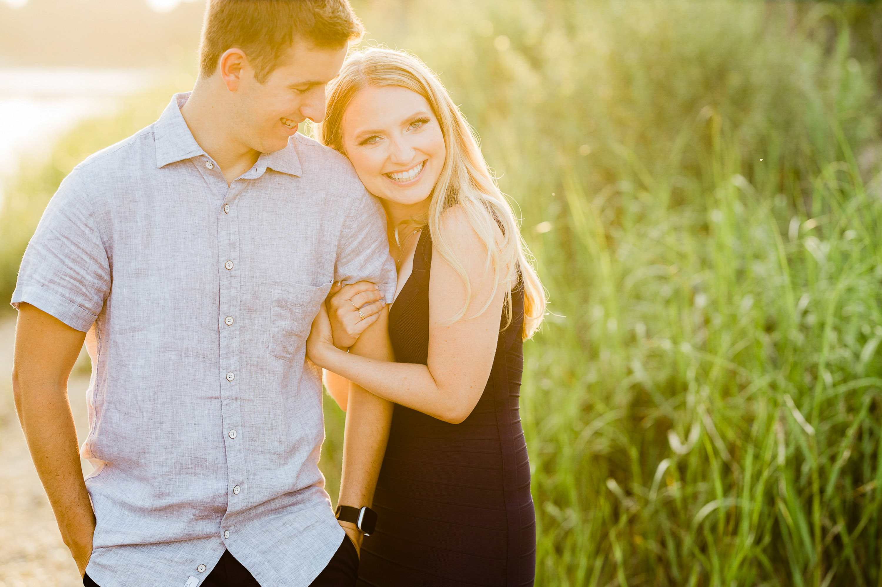 golden hour engagement photos at White Rock Lake Dallas with couple walking together photographed by Dallas engagement photographer Lotus Wedding Photography