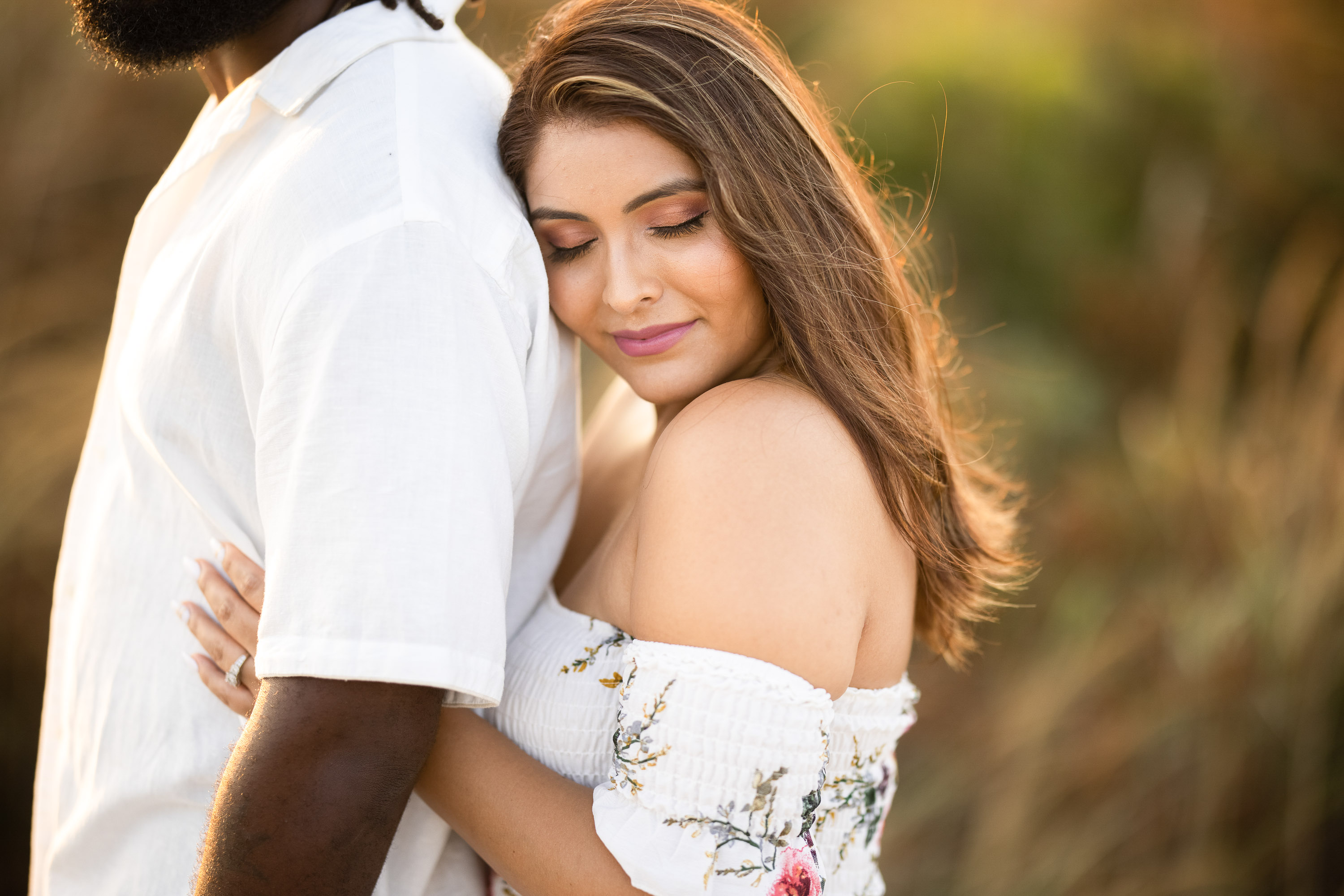 romantic golden hour engagement portrait of couple embracing during Dallas Texas engagement session photographed by Dallas engagement photographer Lotus Wedding Photography
