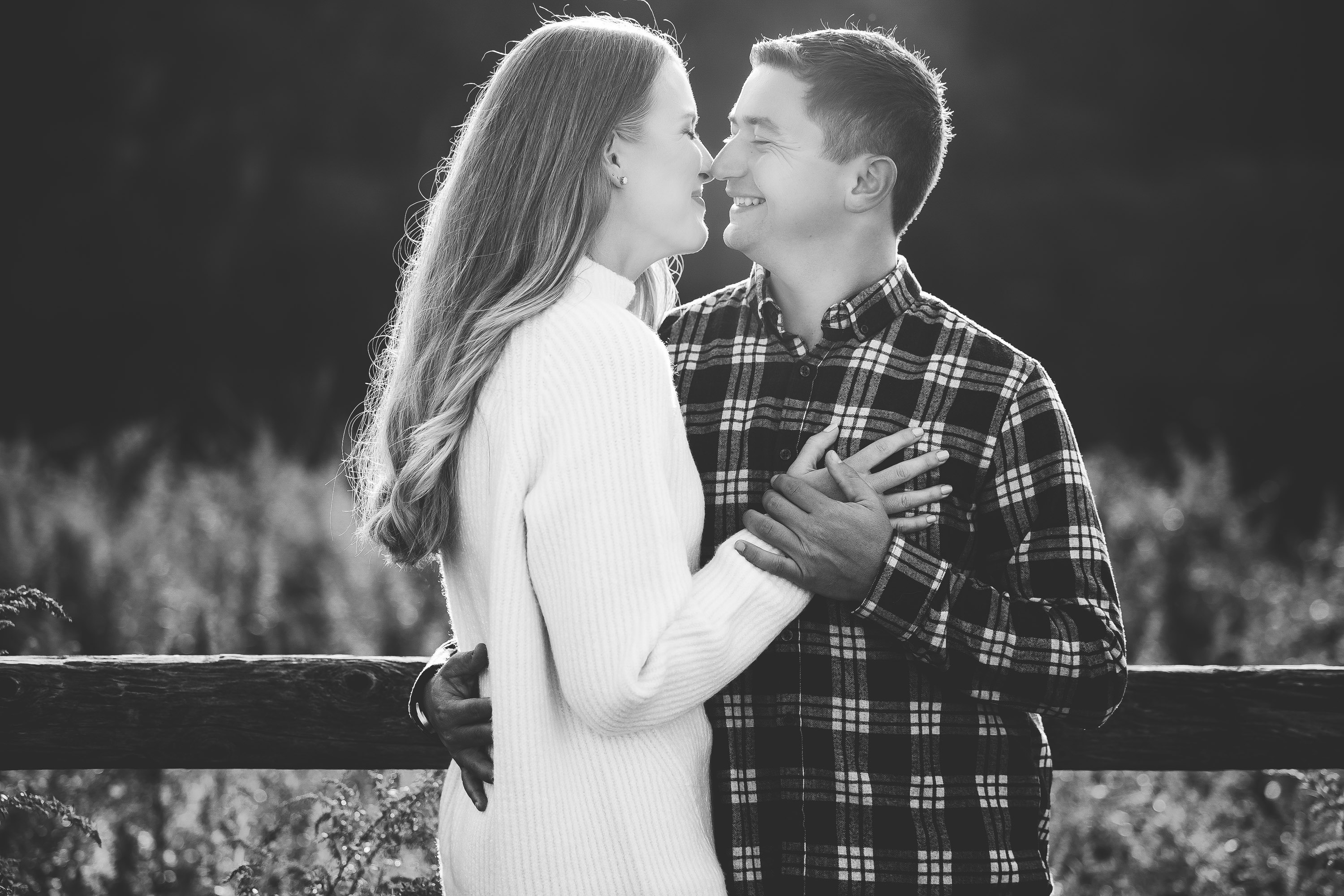 black and white engagement photos at White Rock Lake Dallas with couple embracing photographed by Dallas engagement photographer Lotus Wedding Photography