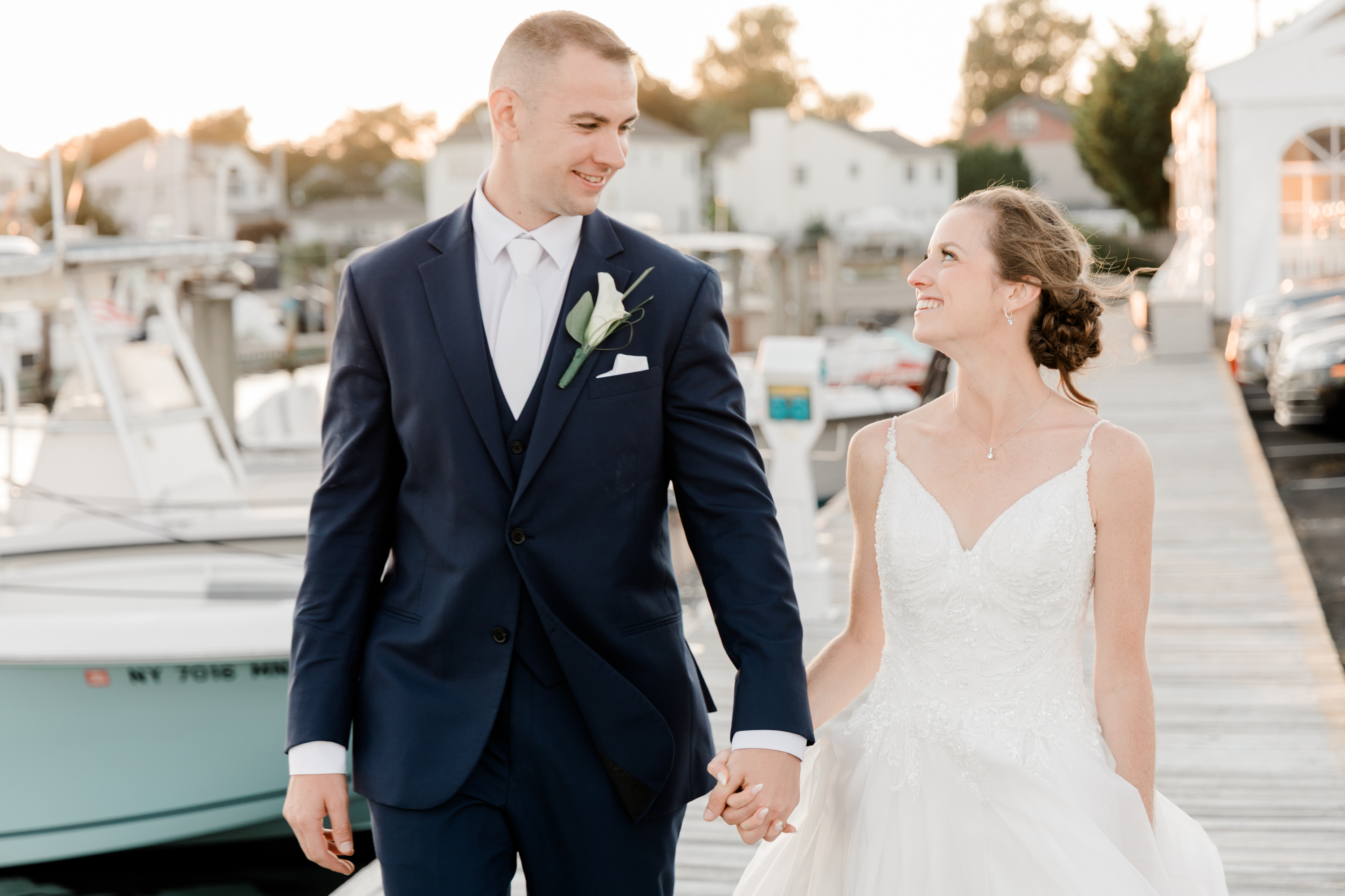 bride and groom holding hands walking together on their wedding day at captian bills