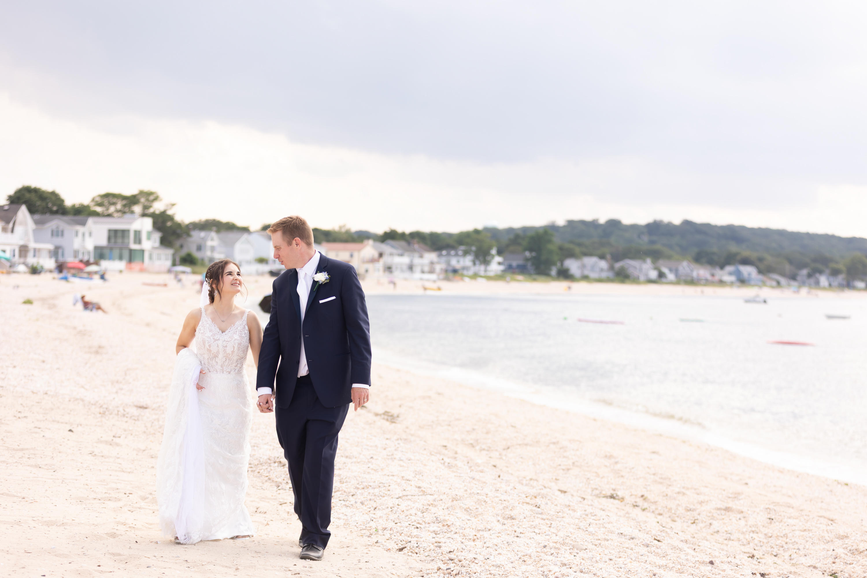 light and airy wedding photo of a bride and groom walking and laughing