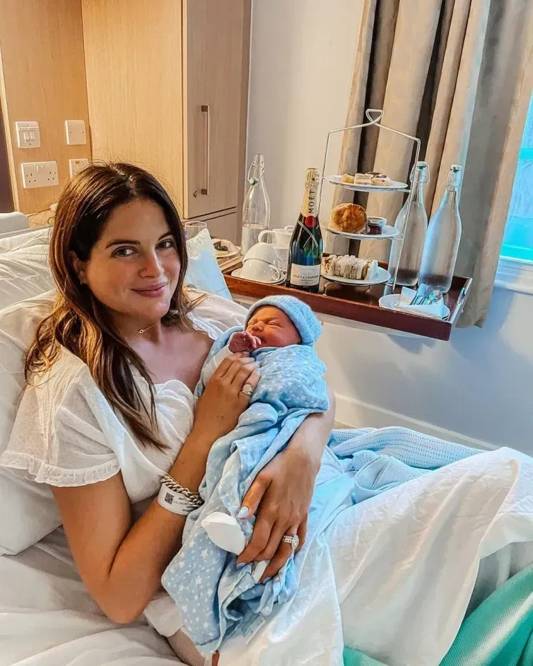 Calm, smiling mother holding her newborn baby after birth, reflecting the confidence and peace that hypnobirthing preparation builds.