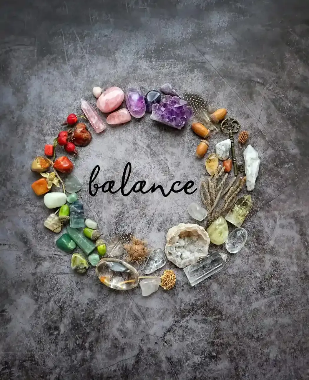 Circle of colorful healing crystals, stones, and natural elements with the word balance at center, representing holistic wellness through life coaching and hypnotherapy.