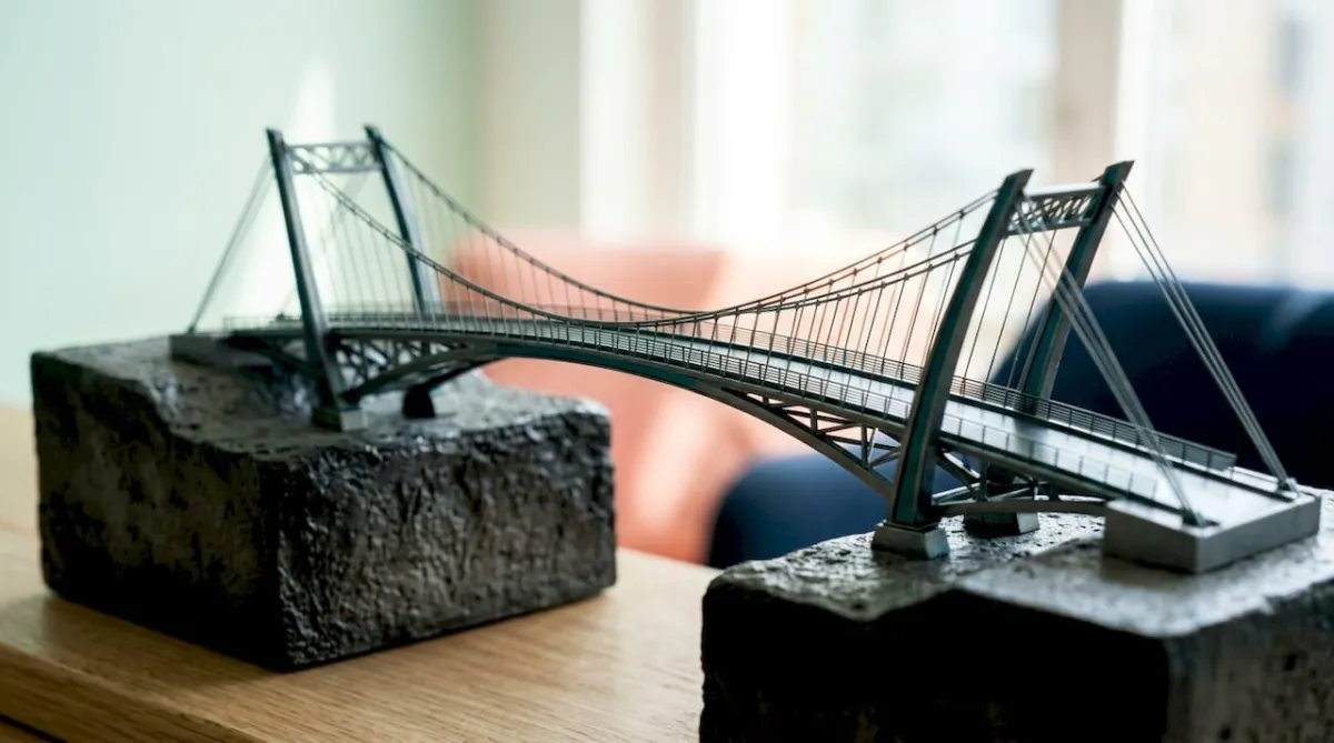 Decorative professional title card with bridge and career icons