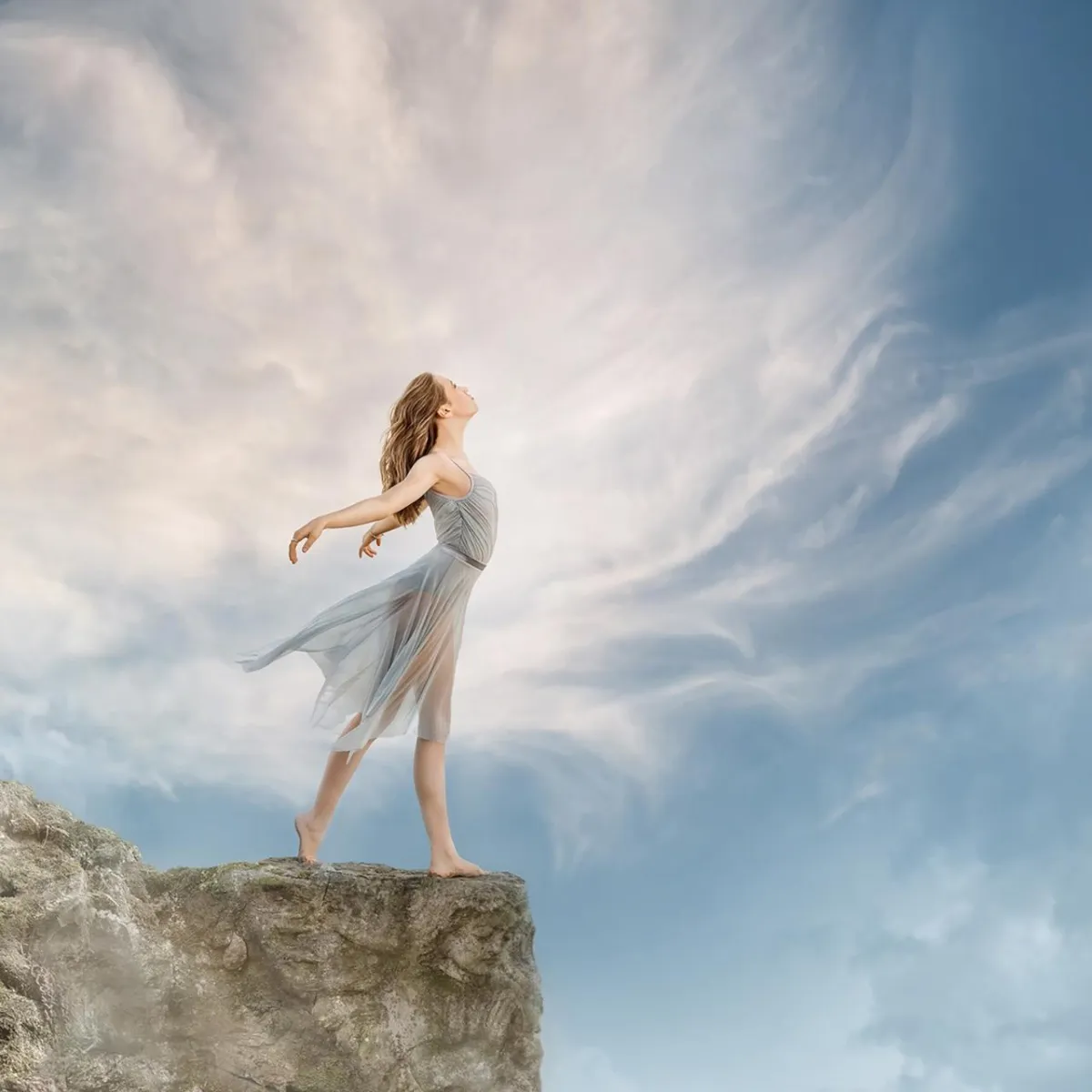 portrait of a girl dancer on a cliff with an angel carved in the rock by Alana Lee