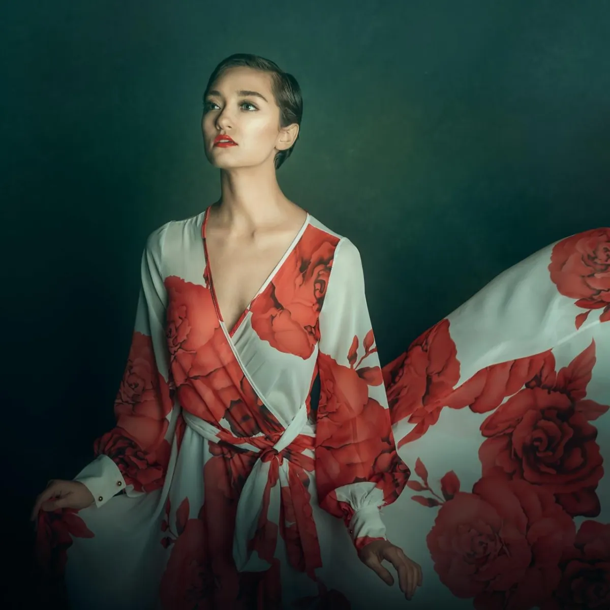 portrait of a model wearing a white and red rose flying dress by Alana Lee