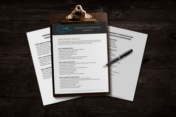 Photography contract customization checklist on clipboard with legal resource documents and pen on dark wooden desk