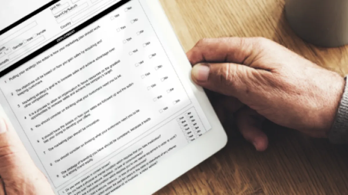 person holding red and black handle stainless steel fork