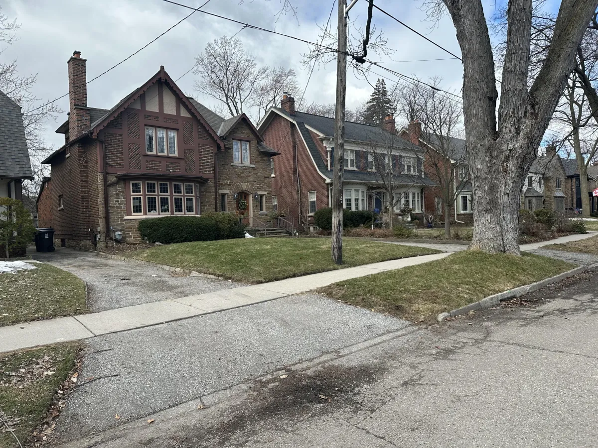 a modern house with a pool and lounge chairs