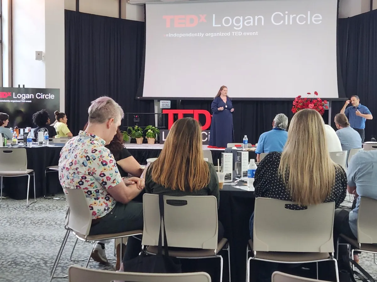 Melissa Hunt speaking on the TEDx stage about the future of senior care.