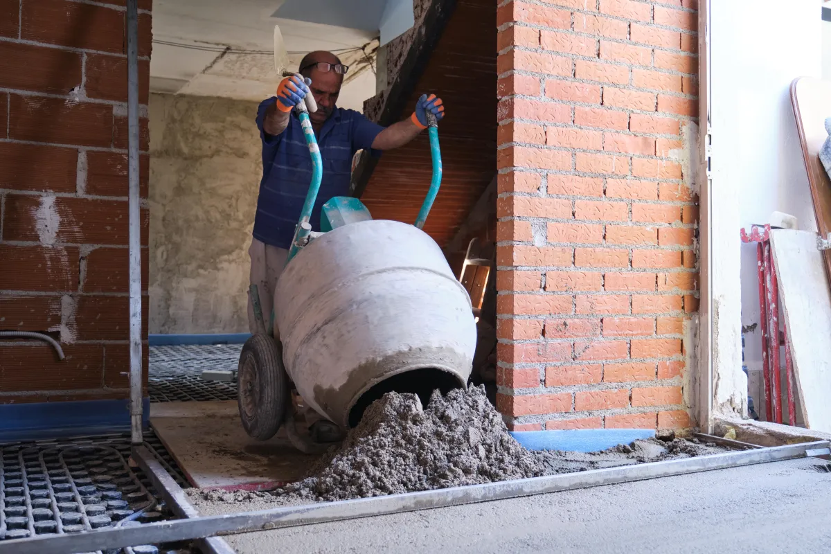 builder-pouring-concrete-from-the-concrete-mixer