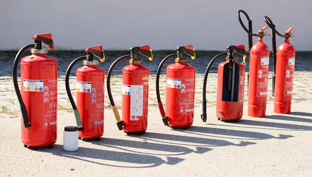 a red fire extinguisher hanging on a wall
