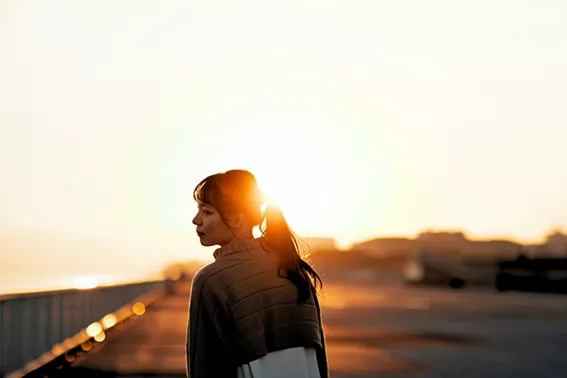 woman on pier gazing out to sea