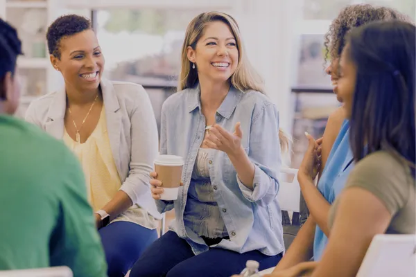 woman sitting together laughing and sharing