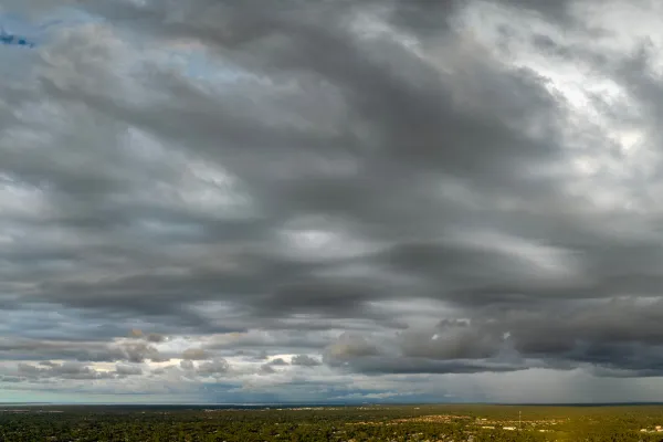 Hail formation image: A cross-section diagram of a thunderstorm showing hail formation in updraft columns — Caption: "Hail doesn't form like rain. Understanding what it is explains why standard covers don't stop it."