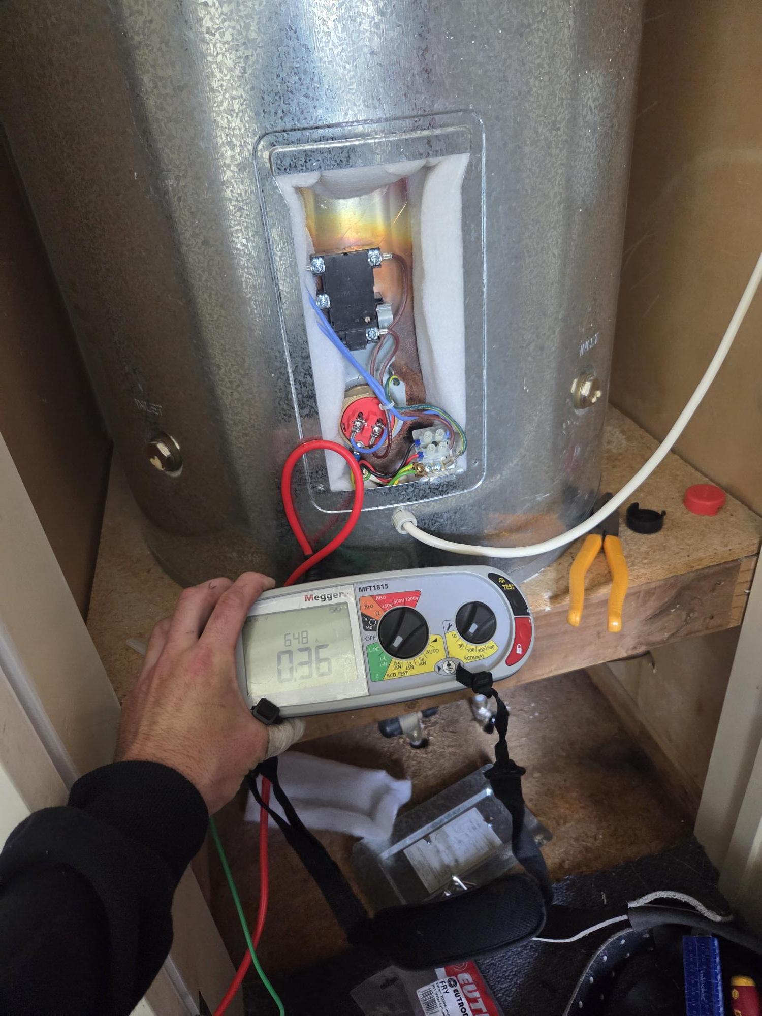 Electrical testing and maintenance on a hot water cylinder by a Wellington electrician
