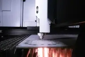 Hands using a digital caliper to measure metal part.