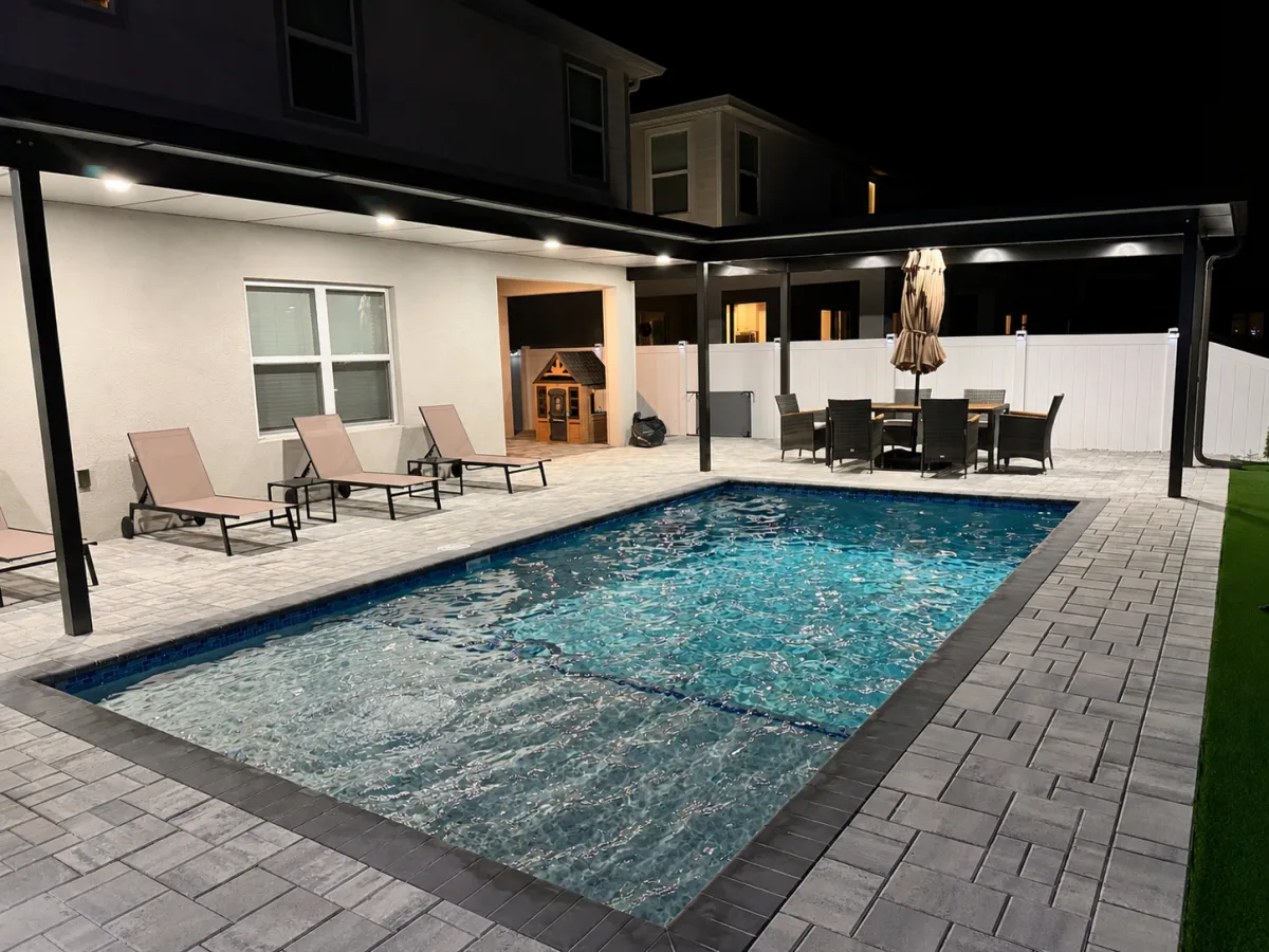 Luxury pool patio with custom pergola and premium paver installation in Florida