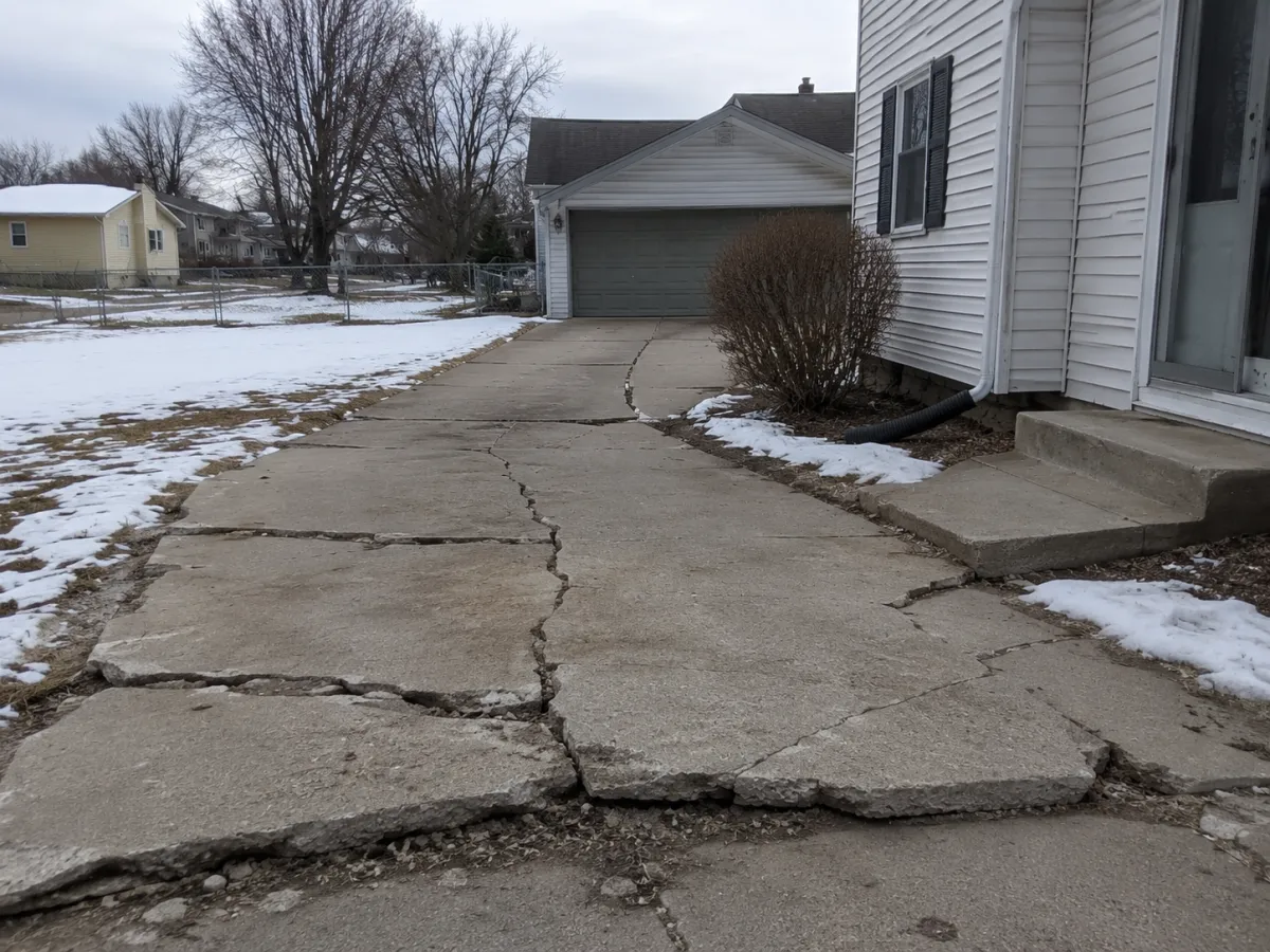 cracked and sunken concrete slab driveway
