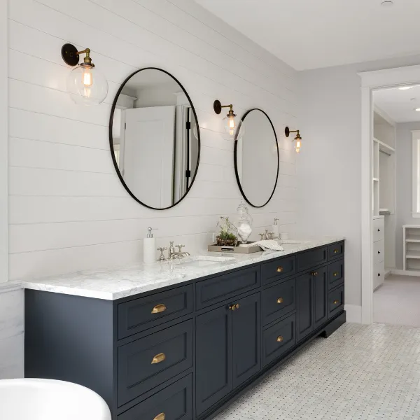 Bathroom remodel with tub to shower conversion gray cabinets and herringbone tile wall