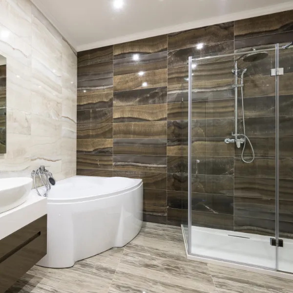Custom bathroom design with corner shower glass doors and natural stone wall tiles