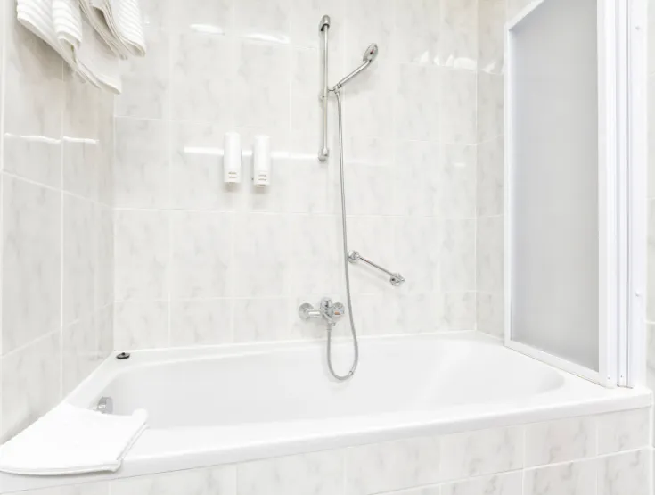Bathtub to shower conversion with wall-mounted fixtures in Pennsylvania bathroom remodel