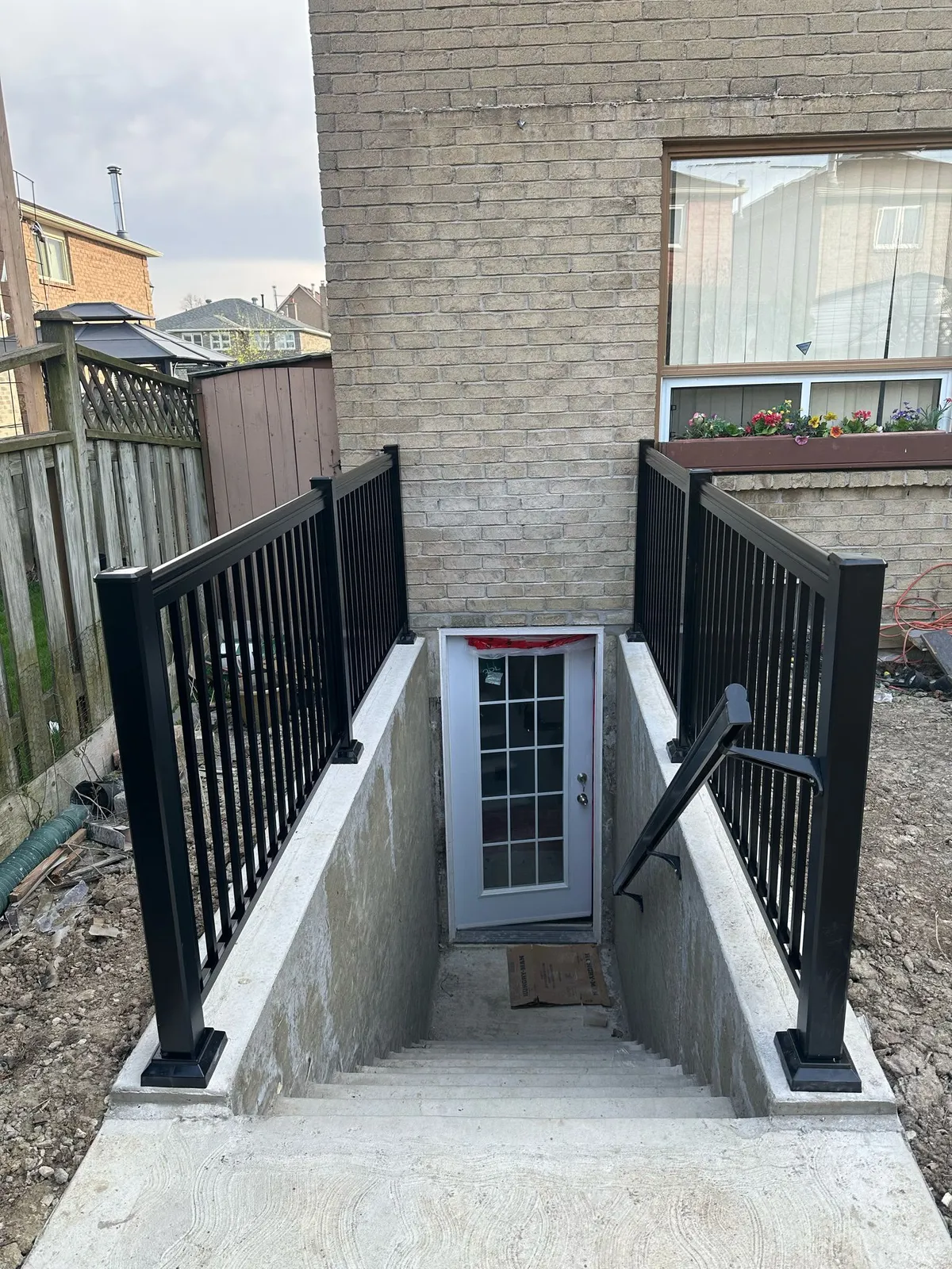 Rising Hill separate entrance with concrete stairwell and black railings