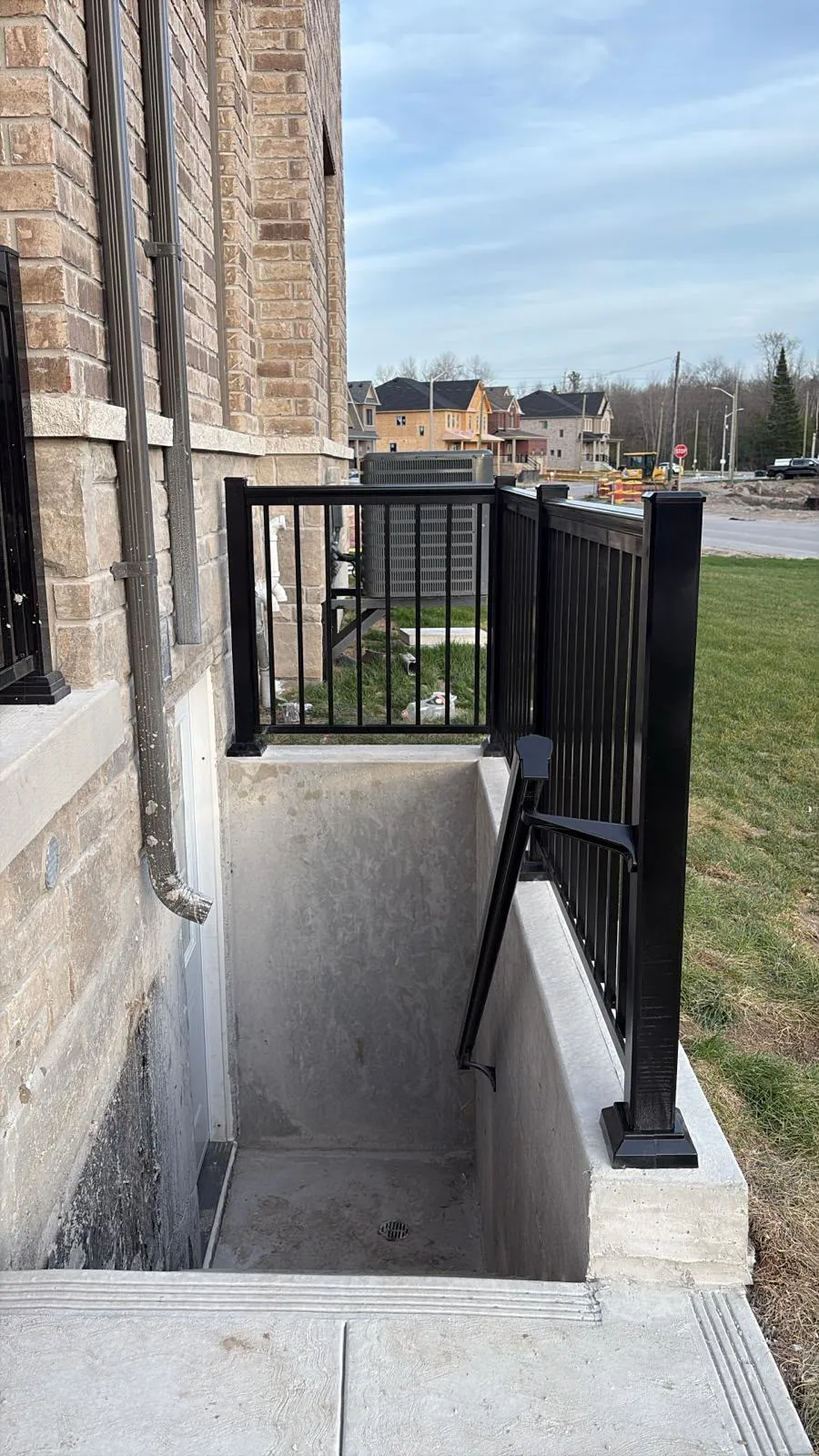 Rising Hill side entrance stairwell with black metal guardrails