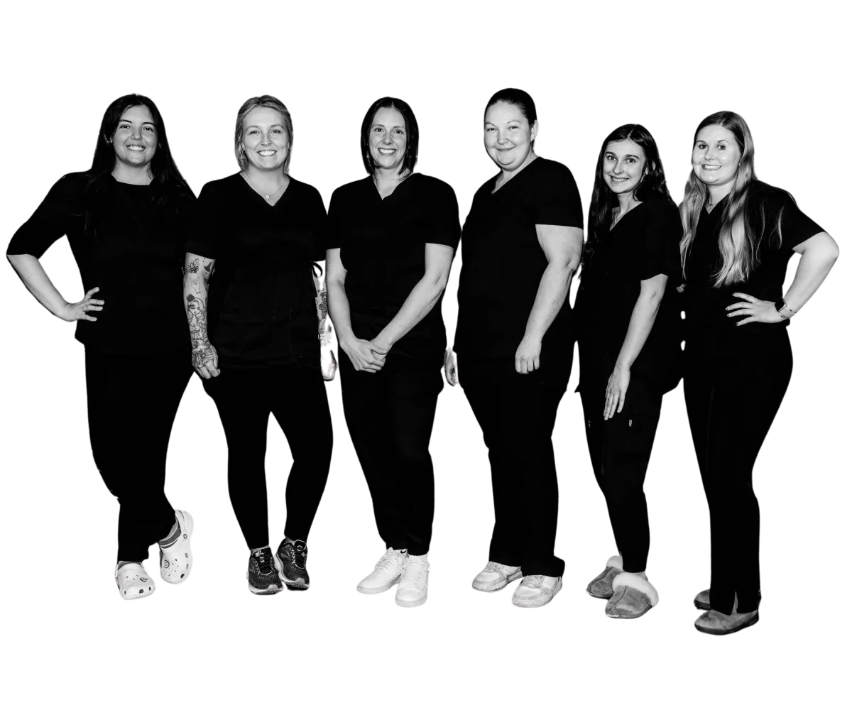 DayMaker Cleaning Co. team standing together smiling in black uniforms