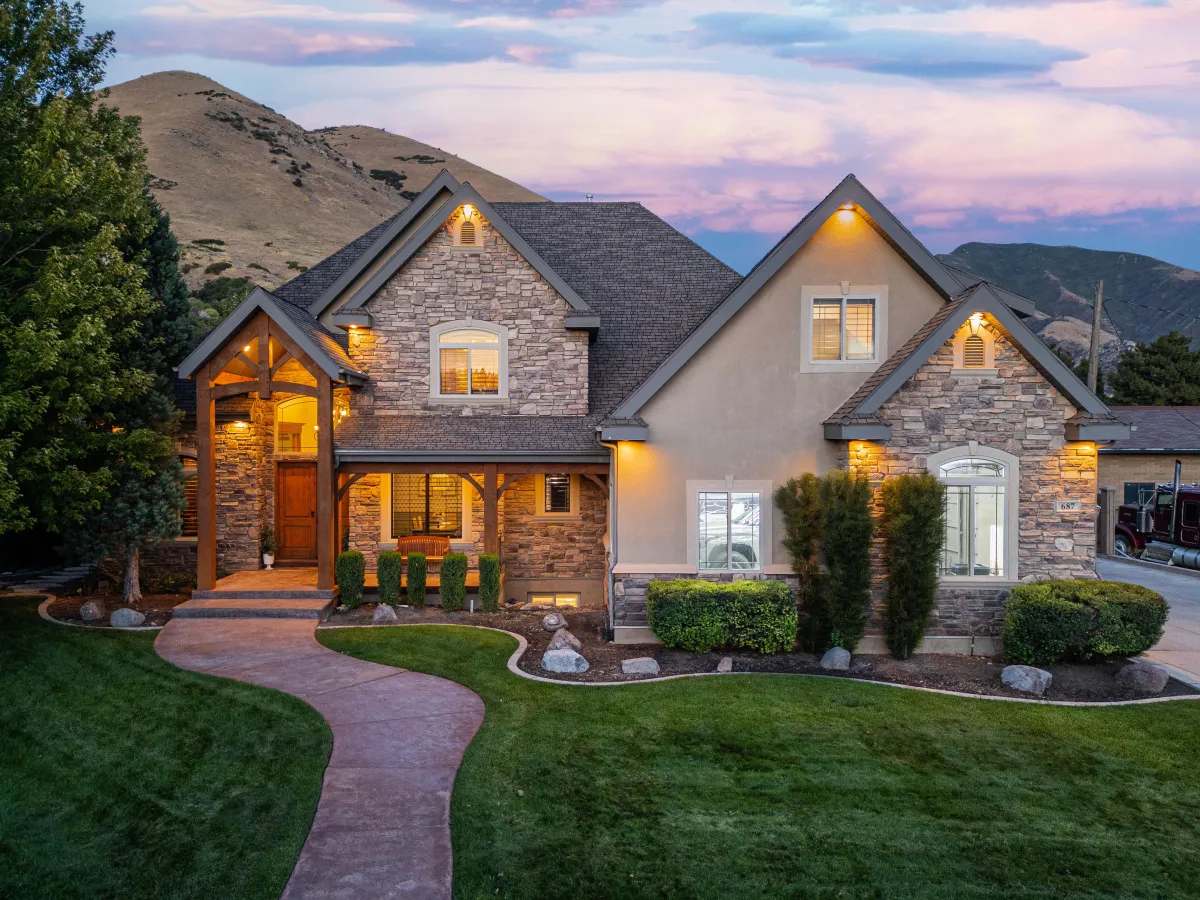 Luxury stone and stucco home in Utah with mountain views at sunset
