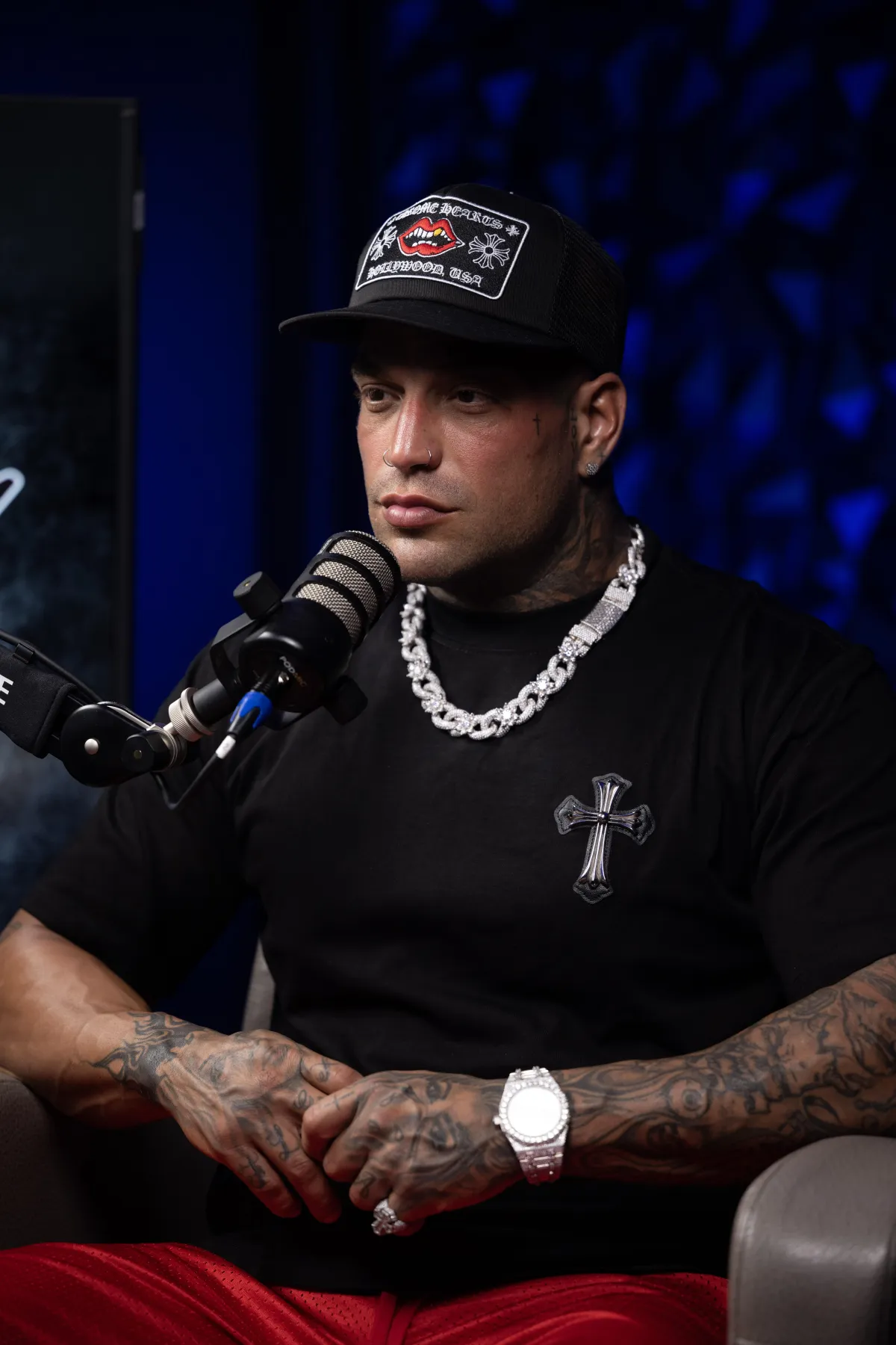a crowd of people walking along a pier next to a ferris wheel