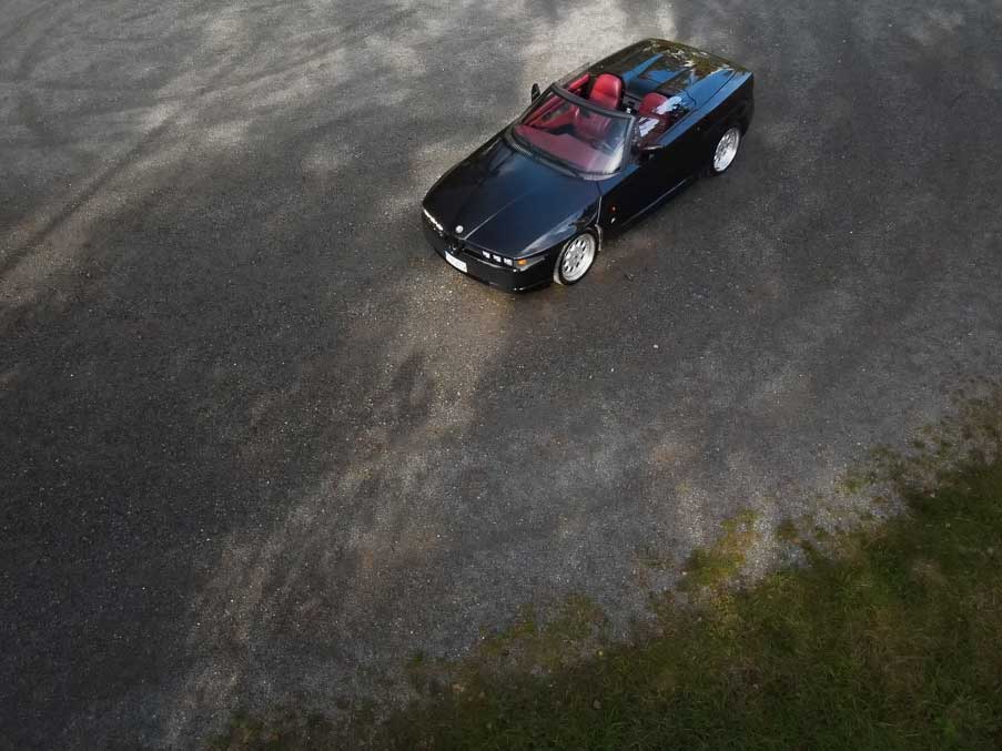 black Alfa romeo rz - parked on  a gravel without top
