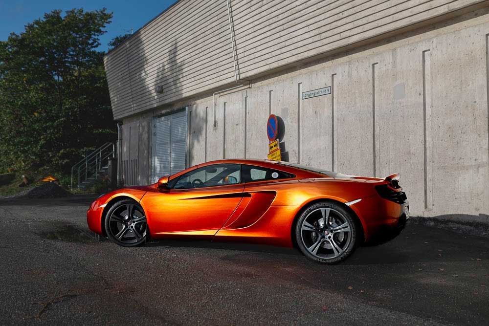 Mclaren mp4-12c  from left side at a concrete builing