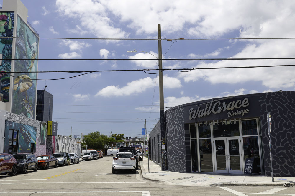 outside walt Grace on the street - with a big shark on the wall