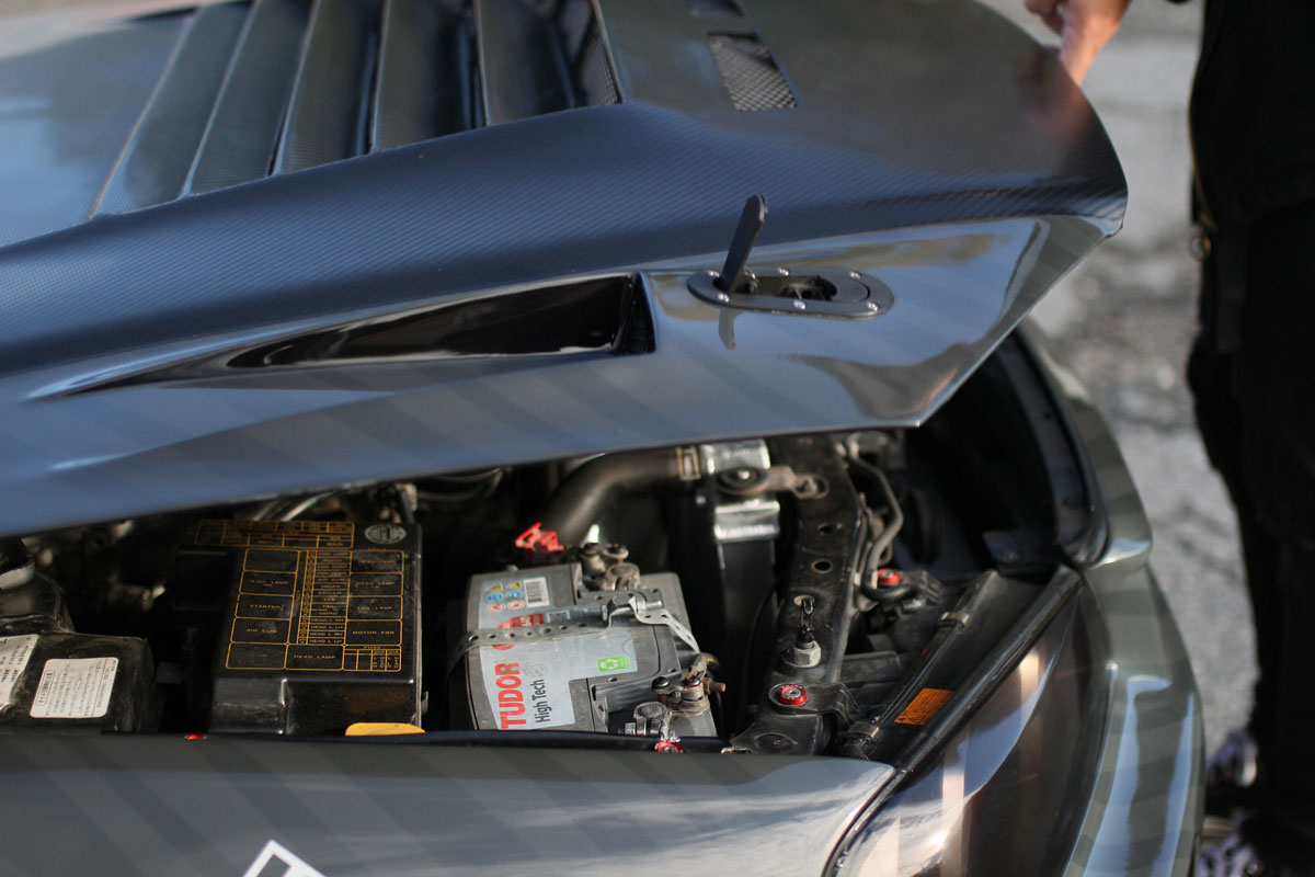 opening the carbon hood of a nissan r34