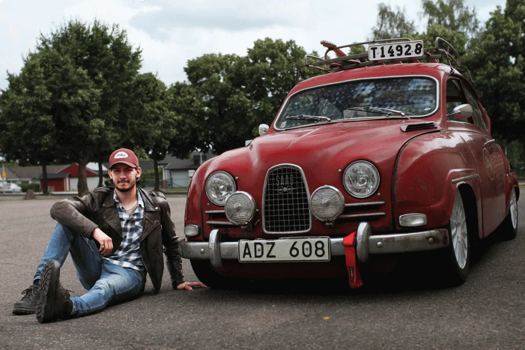 rickars is sitting beside his saab 96