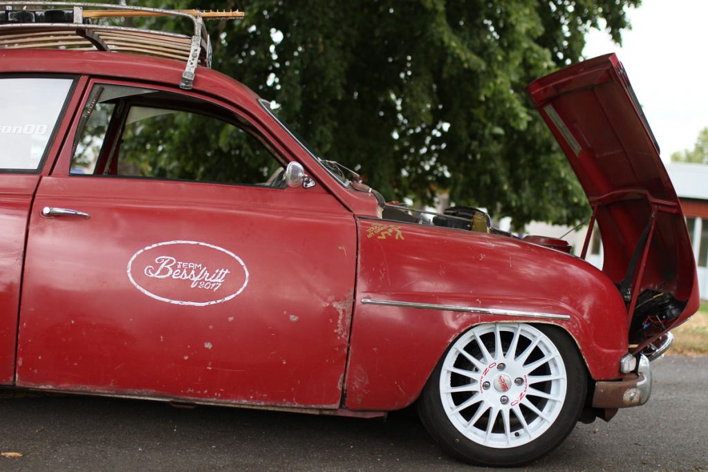 the profile of saab 96 with the hood open