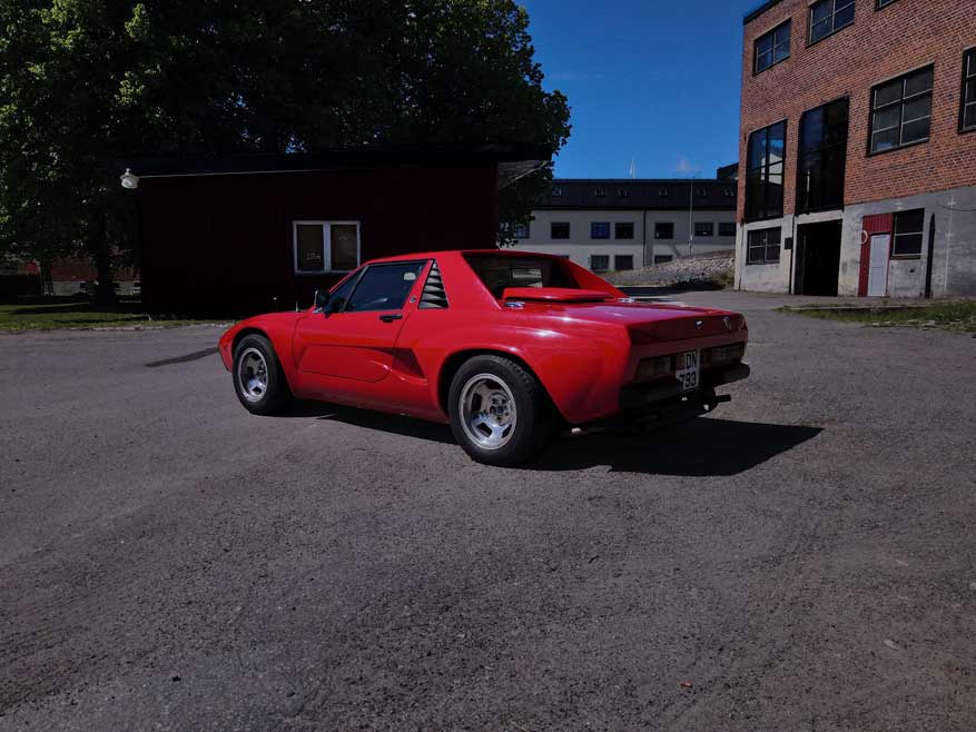 black Alfa romeo rz - parked on  a gravel without top
