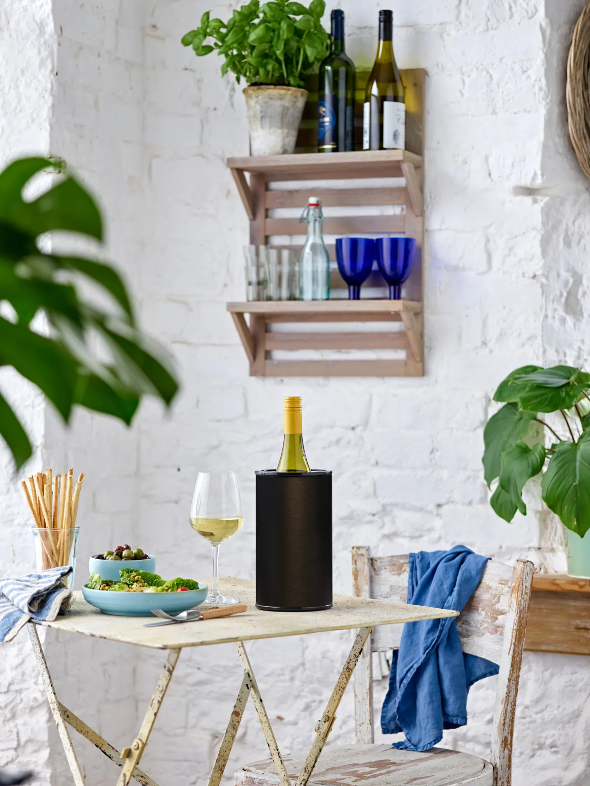 The Hielo wine cooler sitting on a table inside a bright home