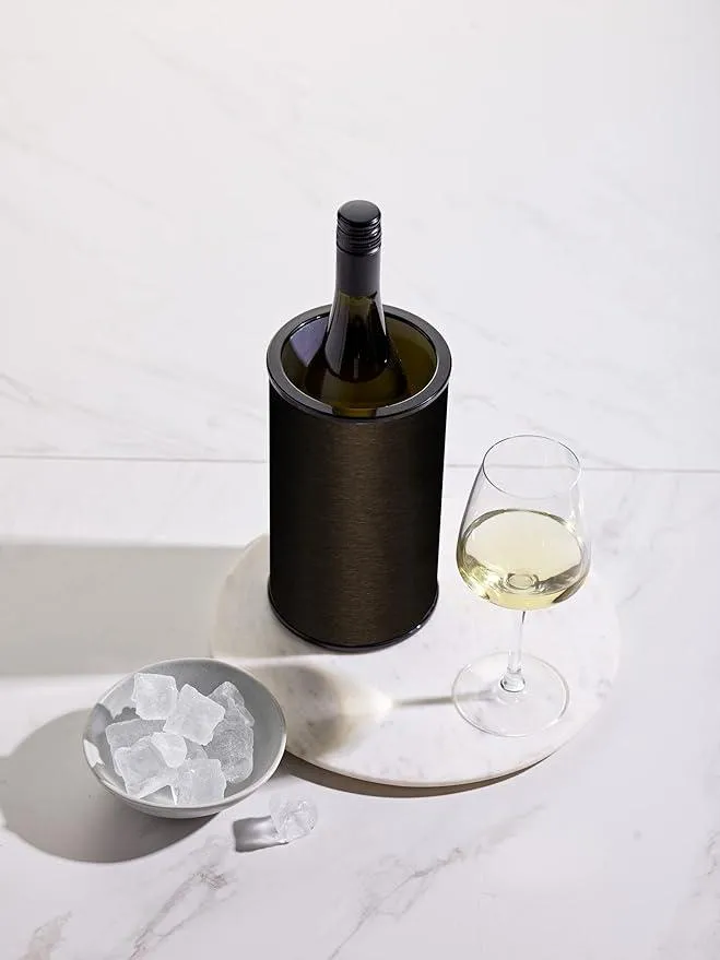 The Hielo wine cooler on a marble table next to a wine glass