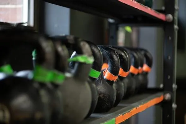 Kettlebells lined up on a rack at Crooked River CrossFit for a beginner-friendly CrossFit workout