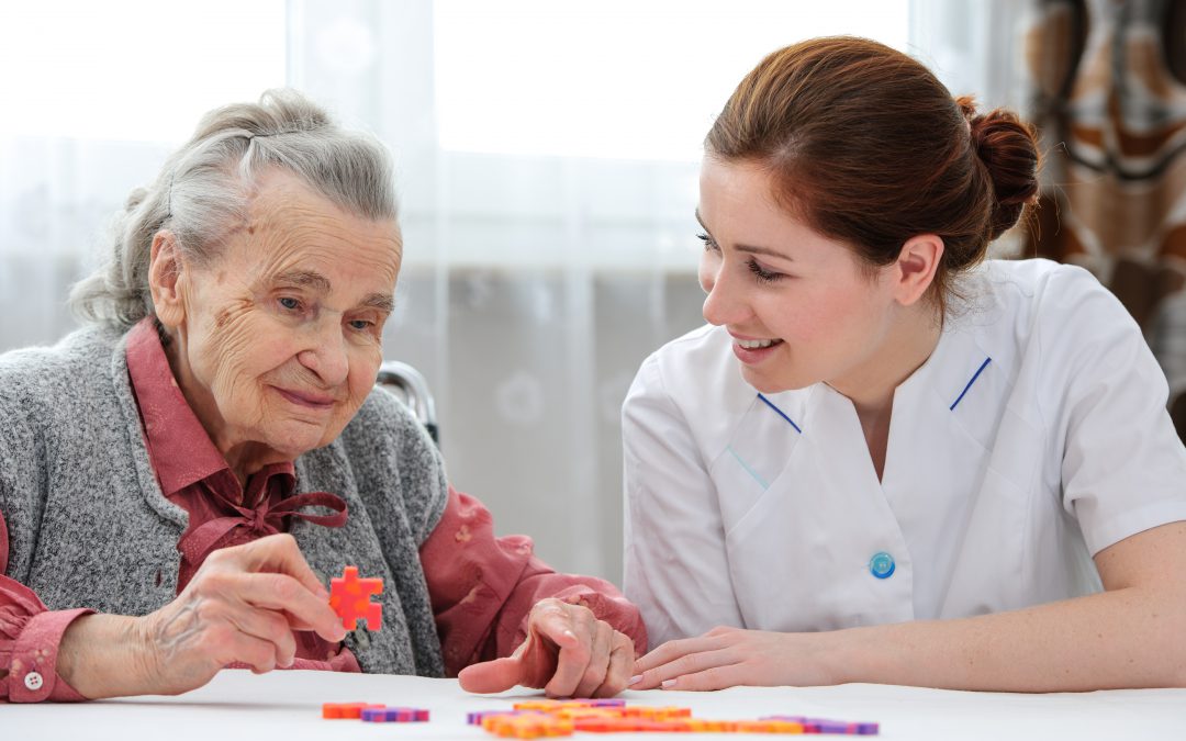 Nurse smiling with elderly patient in room