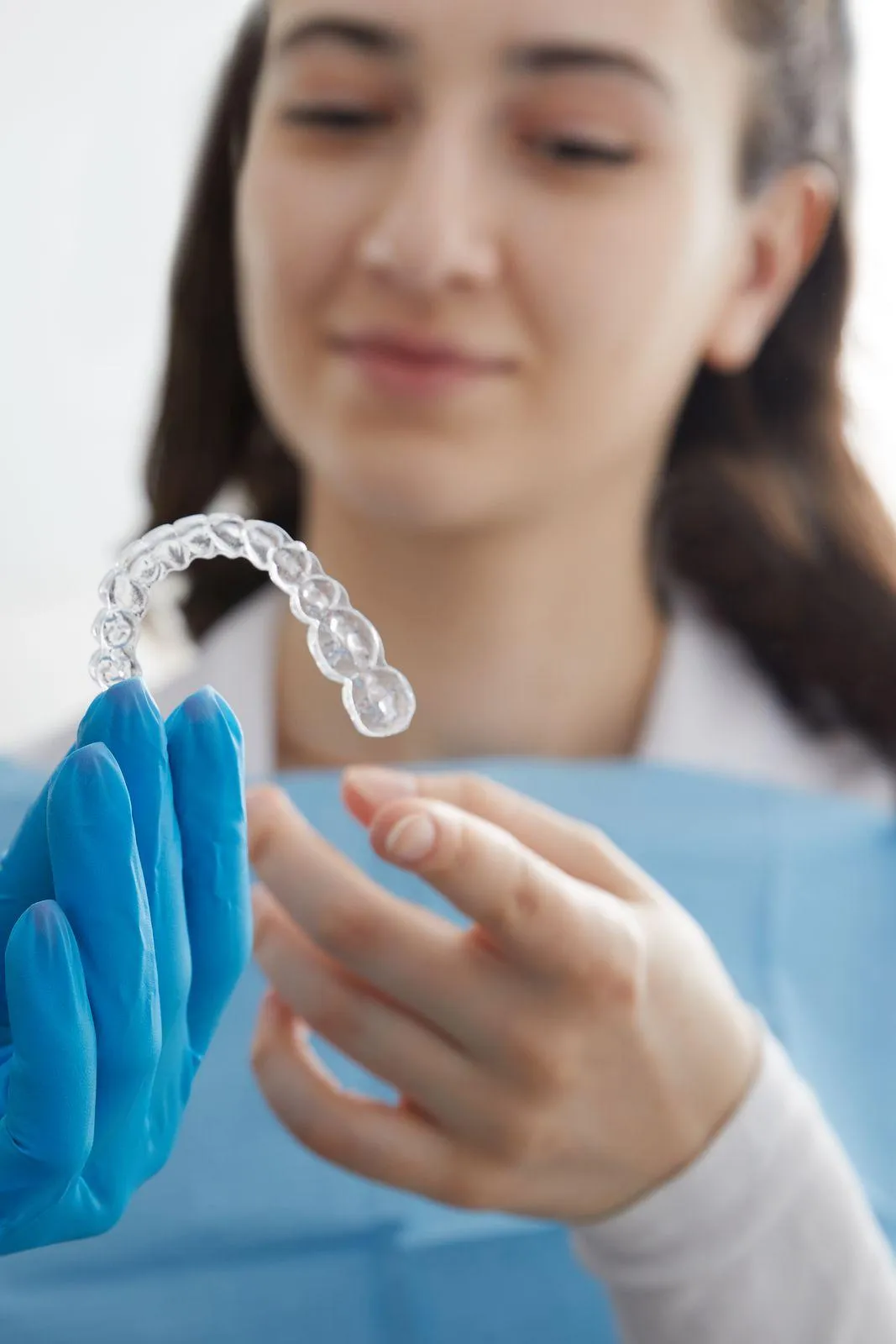 a person pointing at mouth guards