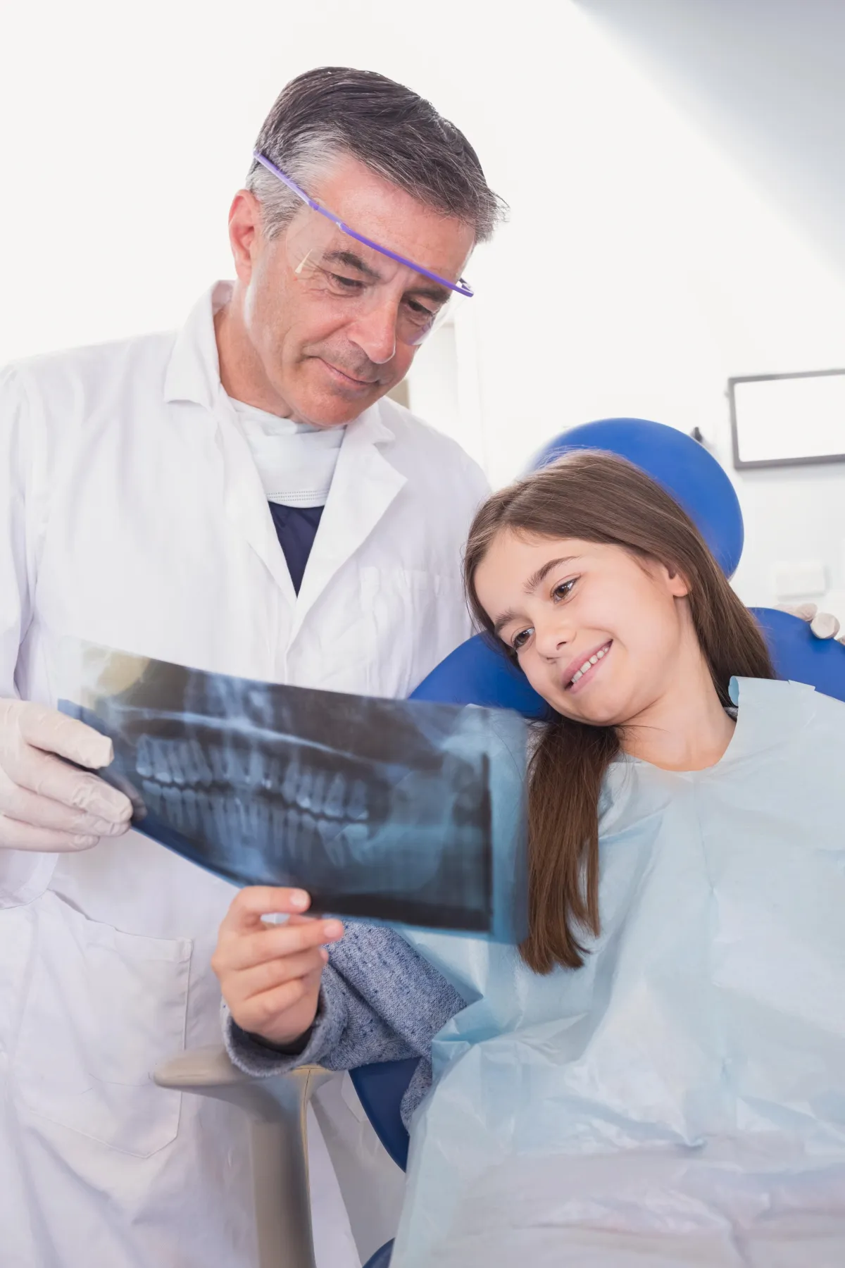 a dentist holding a dental tool over a person's mouth