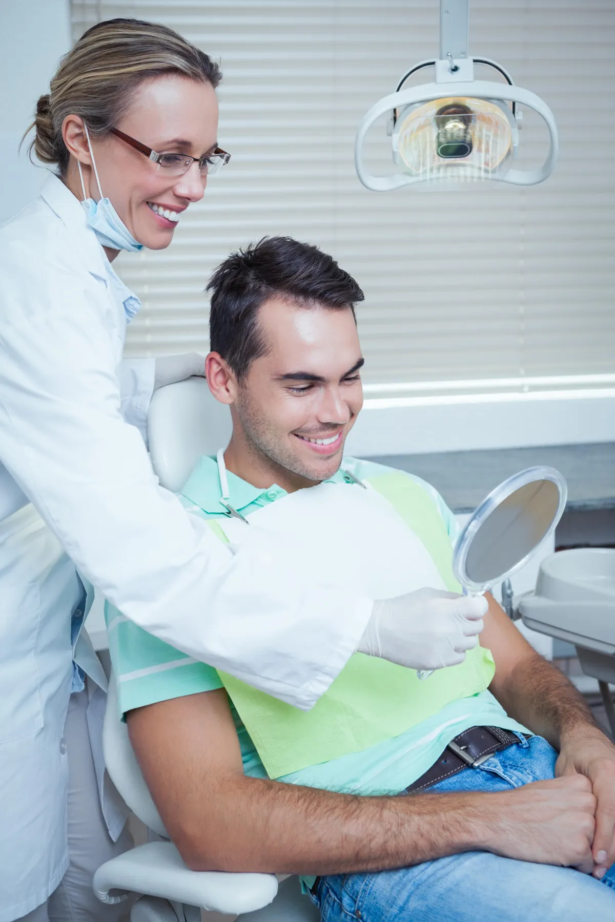 a dentist holding a dental tool over a person's mouth