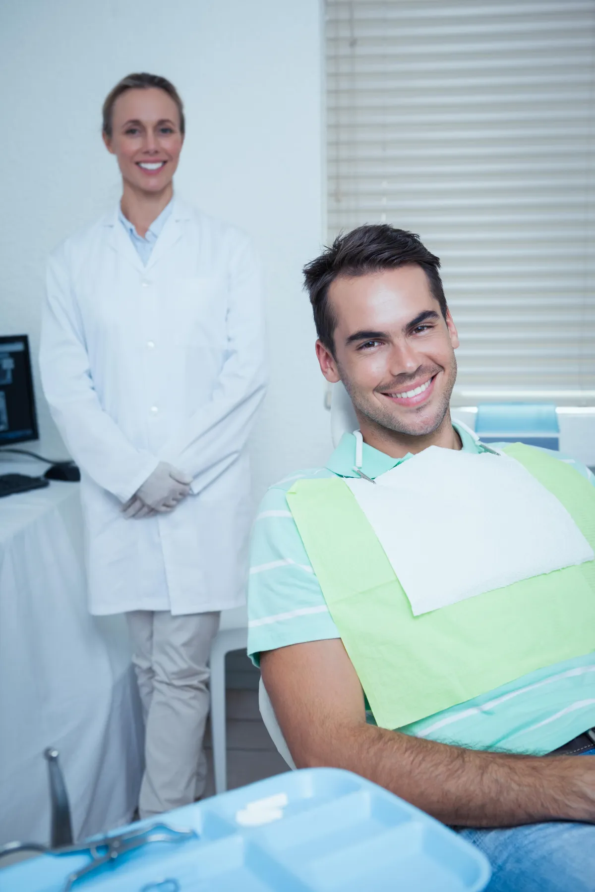 a dentist holding a dental tool over a person's mouth